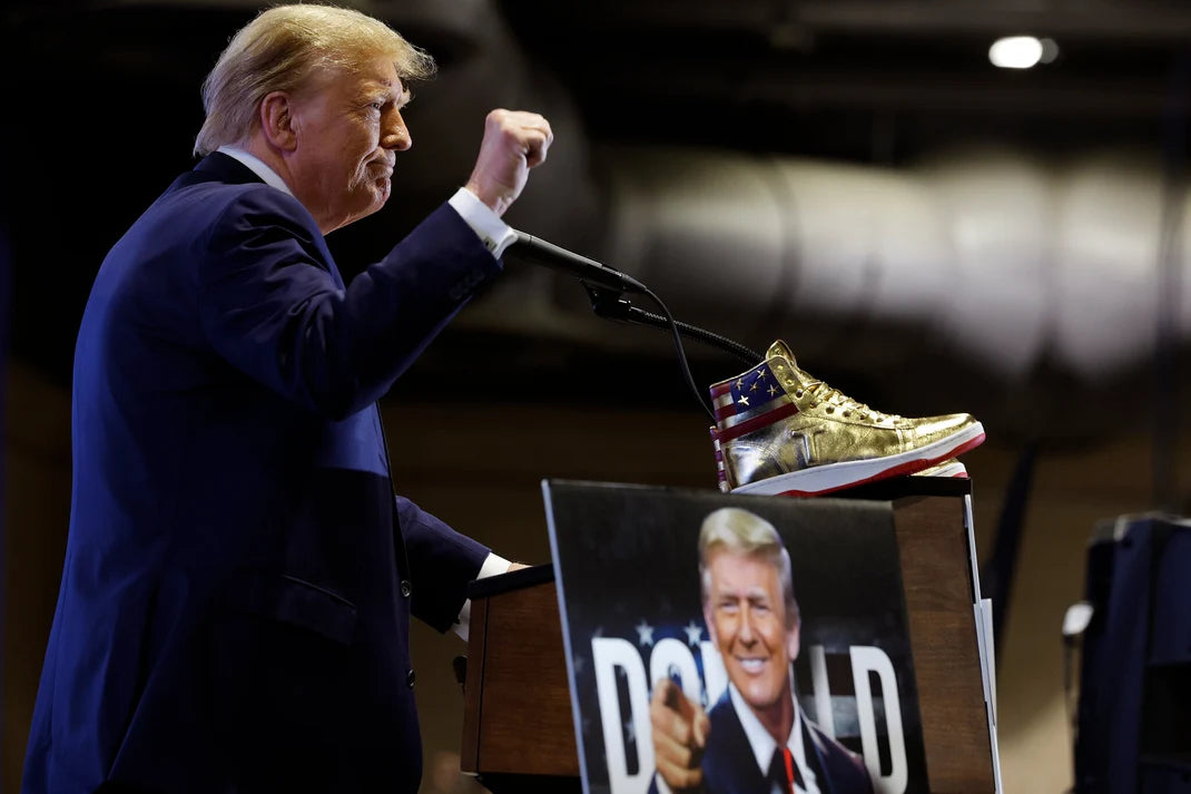 Donald Trump raising Never Surrender sneaker on stage